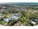 An aerial view shows a charming light blue house with a pool in a residential area at 401 Shore Rd, Nokomis, FL 34275