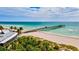 Aerial view of beach, pier, and ocean at 401 Shore Rd, Nokomis, FL 34275