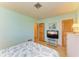 Bedroom with TV, dresser, and access to other rooms at 401 Shore Rd, Nokomis, FL 34275