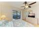 Bright bedroom with a queen-size bed and access to a private balcony at 401 Shore Rd, Nokomis, FL 34275