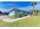 House exterior showcasing a light blue color, walkway and landscaping at 401 Shore Rd, Nokomis, FL 34275