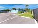 Exterior view of a light blue house with parking and tropical landscaping at 401 Shore Rd, Nokomis, FL 34275