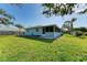 View of the house from the backyard showcasing the screened porch at 401 Shore Rd, Nokomis, FL 34275