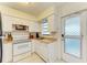 Well-equipped kitchen with white cabinets and stainless steel appliances at 401 Shore Rd, Nokomis, FL 34275