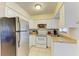 Clean kitchen featuring white cabinets and stainless steel appliances at 401 Shore Rd, Nokomis, FL 34275