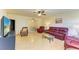 Bright living room with hardwood floors, comfortable seating, and views to dining area at 401 Shore Rd, Nokomis, FL 34275