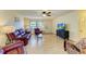 Relaxing living room with leather furniture, hardwood floors, and a large TV at 401 Shore Rd, Nokomis, FL 34275