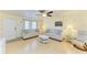 Living room with light beige sofas, hardwood floors, and a ceiling fan at 401 Shore Rd, Nokomis, FL 34275