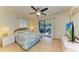 Main bedroom with king-size bed and sliding doors to patio at 401 Shore Rd, Nokomis, FL 34275