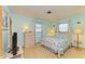 Main bedroom with a queen bed and light wood floors at 401 Shore Rd, Nokomis, FL 34275