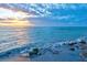 Ocean waves rolling onto the beach at sunset at 401 Shore Rd, Nokomis, FL 34275