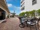 Outdoor patio with seating area, umbrella, and brick pavers at 4239 Gulf Of Mexico Dr # Mh4, Longboat Key, FL 34228