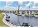 Aerial view of waterfront community with boats and lush landscaping at 4350 Chatham Dr # 208, Longboat Key, FL 34228