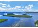 Aerial view showcasing waterfront property and lush landscaping at 4350 Chatham Dr # 208, Longboat Key, FL 34228