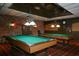 Game room with two billiard tables and brick accent walls at 4350 Chatham Dr # 208, Longboat Key, FL 34228