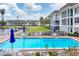 Community pool with surrounding patio furniture at 4350 Chatham Dr # 208, Longboat Key, FL 34228