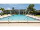 Community swimming pool with ample deck space at 4350 Chatham Dr # 208, Longboat Key, FL 34228