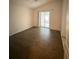 Bright bedroom featuring wood-look floors and sliding glass doors to a patio at 4527 Fern Dr # 26, Bradenton, FL 34208