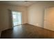 Spacious bedroom with wood-look floors and access to a patio at 4527 Fern Dr # 26, Bradenton, FL 34208