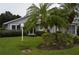 Gray house with palm trees and landscaped lawn at 4527 Fern Dr # 26, Bradenton, FL 34208