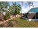 Side yard with a screened patio and grassy area at 4534 Pike Ave, Sarasota, FL 34233