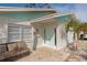 Front entryway with light teal door and seating area at 4534 Pike Ave, Sarasota, FL 34233