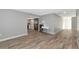 Living room with wood-look floors and view of kitchen at 4534 Pike Ave, Sarasota, FL 34233