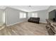 Spacious living room with dark brown couch and wood-like floors at 4534 Pike Ave, Sarasota, FL 34233