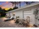 Back patio with lounge chair and small table and chairs at sunset at 4534 Pike Ave, Sarasota, FL 34233