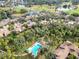 Aerial view of community with pool, golf course, and lake at 4555 Forest Wood Trl # 23, Sarasota, FL 34241