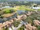 Aerial view of home and community near golf course and lake at 4555 Forest Wood Trl # 23, Sarasota, FL 34241