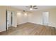 Spacious bedroom with wood-look flooring and access to bathroom at 4555 Forest Wood Trl # 23, Sarasota, FL 34241