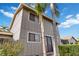 Rear exterior view showcasing gray siding and private backyard at 4555 Forest Wood Trl # 23, Sarasota, FL 34241