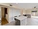 Modern kitchen island with gray cabinets and white counters at 4555 Forest Wood Trl # 23, Sarasota, FL 34241