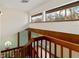 View from staircase overlooking living area with wood beams and natural light at 4555 Forest Wood Trl # 23, Sarasota, FL 34241