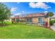 Screened pool and patio area, lush landscaping at 4653 Royal Dornoch Cir, Bradenton, FL 34211