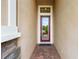 Inviting entryway with red door and brick flooring at 4653 Royal Dornoch Cir, Bradenton, FL 34211