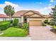 Single-story home with tile roof and landscaped yard at 4653 Royal Dornoch Cir, Bradenton, FL 34211