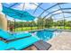 Relaxing screened pool and spa with lounge chairs at 4653 Royal Dornoch Cir, Bradenton, FL 34211