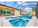 Screened pool and spa with patio furniture and grill at 4653 Royal Dornoch Cir, Bradenton, FL 34211