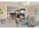 Bright dining area with glass-top table and seating for four, open to living room at 4714 Potomac Cir, Bradenton, FL 34210