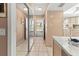 Tiled entryway with mirror and view to the kitchen at 4714 Potomac Cir, Bradenton, FL 34210