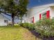 Landscaped yard with lush greenery and red shutters at 4714 Potomac Cir, Bradenton, FL 34210