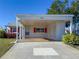 House exterior with carport and red shutters at 4714 Potomac Cir, Bradenton, FL 34210