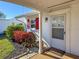 Front door entrance with covered porch and landscaping at 4714 Potomac Cir, Bradenton, FL 34210