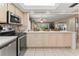 Kitchen features stainless steel appliances and light wood cabinets at 4714 Potomac Cir, Bradenton, FL 34210