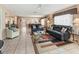 Living room with leather seating, coffee table, and access to the lanai at 4714 Potomac Cir, Bradenton, FL 34210