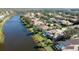 Aerial view of a luxury waterfront community with houses, pools, and lush landscaping at 4821 Hanging Moss Ln, Sarasota, FL 34238