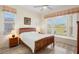 Spacious bedroom with wood-framed bed and large window at 4821 Hanging Moss Ln, Sarasota, FL 34238