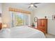 Bright bedroom with wood-framed bed and bay window at 4821 Hanging Moss Ln, Sarasota, FL 34238